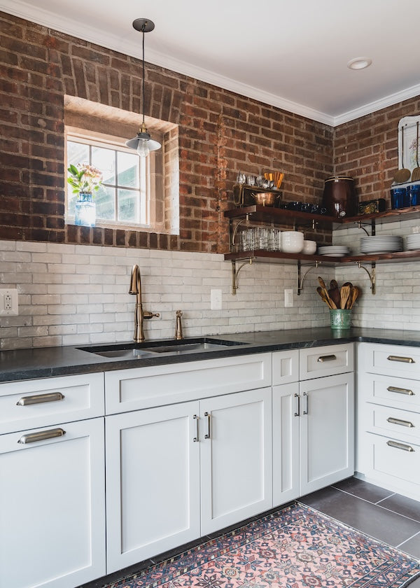 White subway tile backsplash with brick wall in a Bristol CT kitchen